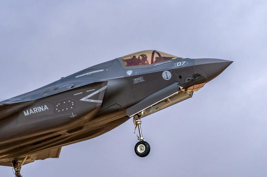 F-35 fighter jet soaring through the sky, showcasing modern military aviation technology.